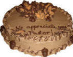Pastor appreciation with fall theme. This cake features chocolate leaves highlighted with orange icing painted on them